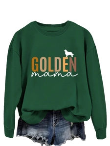 Close-up of Golden Mama print on dark green crewneck sweatshirt with ribbed cuffs