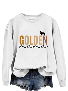 Detail of white sweatshirt featuring GOLDEN mama text and golden retriever silhouette