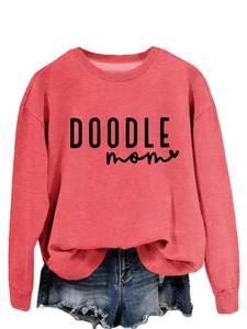 Detail of red crewneck sweatshirt featuring black Doodle Mom text and heart print
