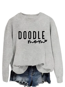 Close-up of DOODLE mom lettering with heart detail on a gray crewneck sweatshirt