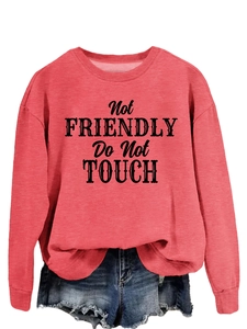 Detail of red crewneck sweatshirt with black Not Friendly Do Not Touch slogan text