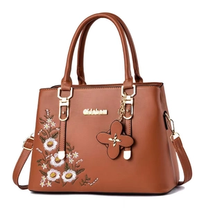 Brown vintage faux leather handbag with white daisy embroidery and gold hardware