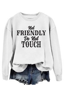Close-up of Not Friendly Do Not Touch vintage text print on white crewneck sweatshirt