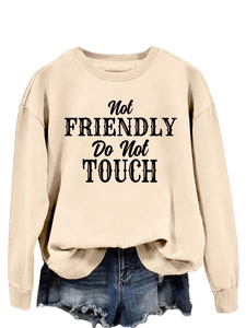 Close-up of Not Friendly slogan print on apricot casual crewneck long sleeve sweatshirt