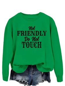 Close-up of green crewneck sweatshirt with Not Friendly Do Not Touch graphic print