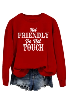 Detail of red crewneck sweatshirt with white Not Friendly Do Not Touch print text