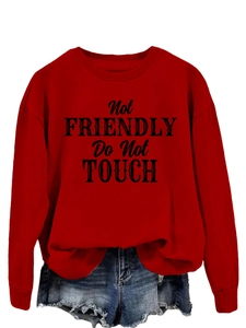 Detail of red long sleeve sweatshirt with black Not Friendly Do Not Touch graphic print
