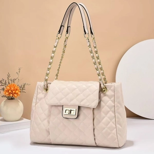 Elegant cream quilted shoulder bag with gold chain strap and metallic twist lock