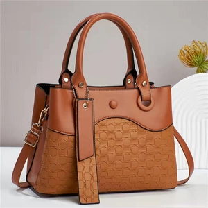 Retro brown women's handbag with woven texture, double handles, and gold hardware detail