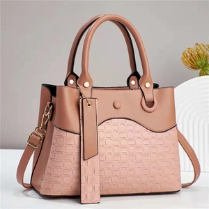Dusty rose handbag for women featuring a woven texture and adjustable shoulder strap