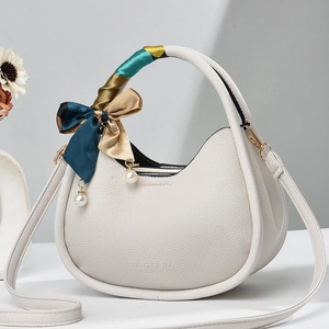 Chic white crescent handbag in pebble leather with silk scarf handle and pearl charms