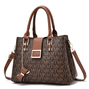 Close-up of brown textured leather with MTM pattern and golden buckle detail