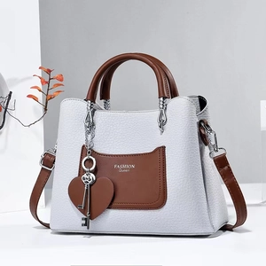 Elegant grey litchi grain shoulder bag with brown handles and a heart charm