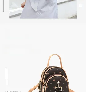Close-up of mini backpack with brown monogram pattern, dual zippers and gold cat charm