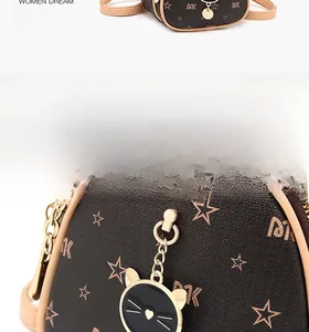 Detailed view of dark brown mini backpack with star pattern and cute black cat metal charm