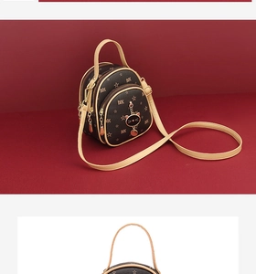 Detail view of the mini backpack with star print, cat pendant, and multiple zippers