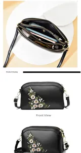 Detailed views of black leather shoulder bag with floral embroidery and triple zipper layers