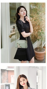 Detail of pea green crossbody bag featuring delicate floral embroidery and leather texture