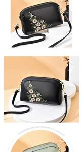 Detail of floral embroidery on cross-body bag with double zippers and gold hardware