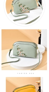 Detail of floral embroidery on daisy pattern crossbody bag with double zipper design