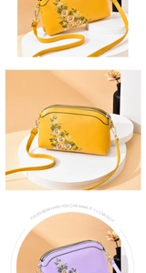 Close-up of triple-layer zipper design and floral embroidery on textured leather bag