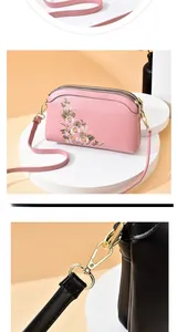 Detail shot of the three-zipper design and floral embroidery on the pink shoulder bag