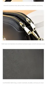 Detail of black litchi grain leather texture and durable gold hardware on the bag