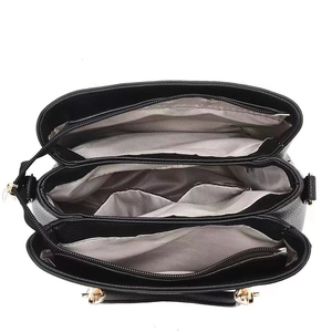 Women's black pebbled leather handbag with triple compartments and gold hardware