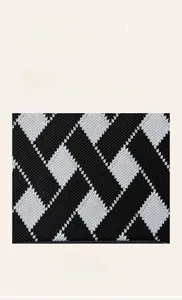 Détail du tissu respirant doux avec motif de losanges noirs et blancs tissés
