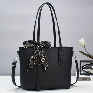 Minimalist black tote bag with silk scarf decoration and adjustable shoulder strap