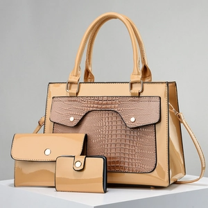 Detailed macro of khaki patent leather 3-piece bag set with croc-embossed texture