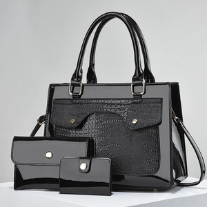 Detailed view of black patent leather 3-piece bag set with crocodile texture embossing