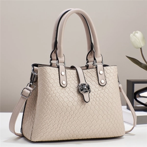 Close-up of beige woven texture handbag featuring a unique flower-shaped metal twist lock