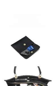 Internal view of large black leather tote bag showing organized multi-layer capacity