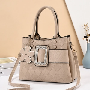 Beige tote bag in pebble leather with quilted texture and rhinestone square buckle detail