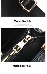 Detail of golden metal hooks and high-quality zipper hardware on a black leather tote bag