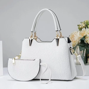 Two-piece white lace embossed handbag set with gold hardware and shoulder strap