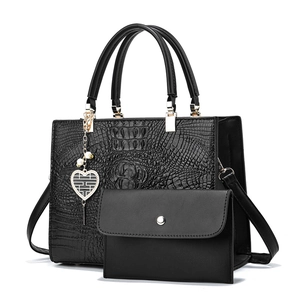 Black crocodile pattern tote bag set with matching pouch and heart charm detail