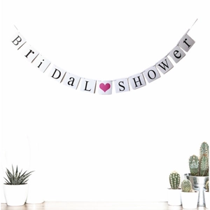 Bridal Shower party banner with black letters and pink hearts on a white background