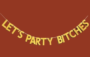 Detail of Let's Party Bitches banner featuring gold glitter texture and sharp lettering