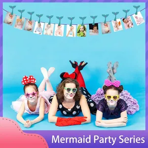 Mermaid birthday party photo banner with sequin fish tail clips and monthly numbers