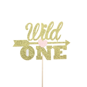 Golden glitter Wild One cake topper with pink heart and arrow for first birthday party