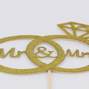 Sparkling gold Mr & Mrs wedding cake topper with interlocking rings and diamond design