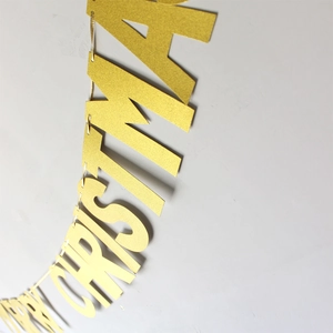 Detail of glittery gold Merry Christmas banner letters against a neutral background