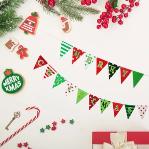 Red and green Merry Christmas bunting flags with festive patterns on a flat lay background