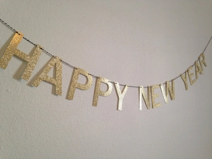 Close-up of gold glitter Happy New Year banner for festive party wall decoration