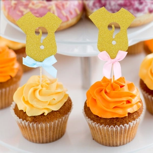 Gold glitter baby bodysuit cupcake toppers with ribbons for gender reveal party