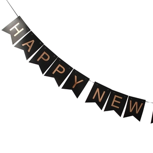 Close-up of Happy New Year black pennants with rose gold foil lettering for party decor