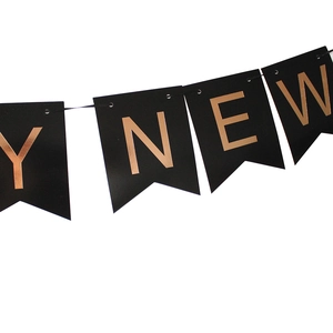 Detail of Happy New Year banner featuring rose gold foil letters on black cardstock