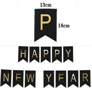 Gold foil Happy New Year banner on black cardstock for festive party decoration